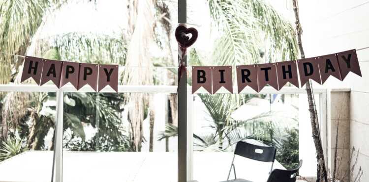 black chair near happy birthday bunting